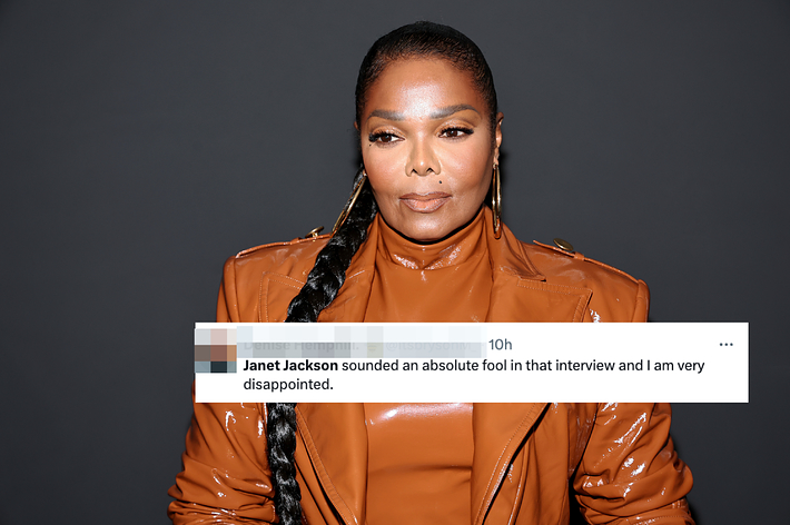 Janet Jackson is wearing a glossy leather jacket with matching turtleneck and long braided ponytail