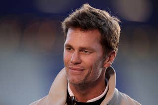 Tom Brady with short hair and a confident expression wears a light jacket